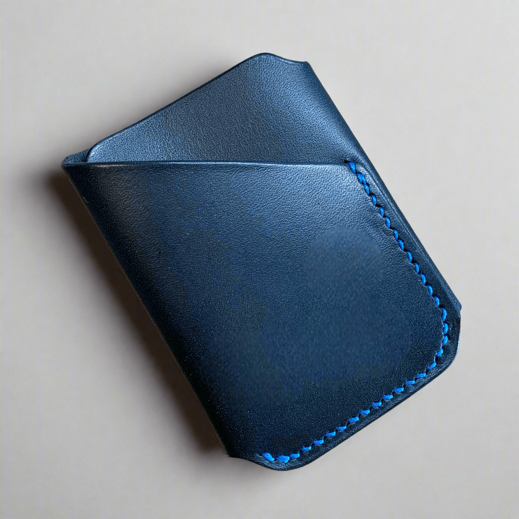 Keep studios wrap wallet in black smooth veg tanned leather with cobalt bluye hand stitching