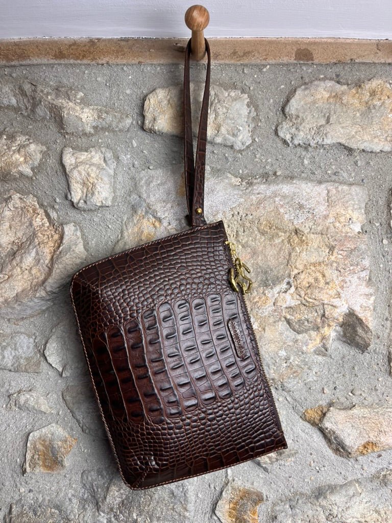 Handmade and hand stitched Brown croc leather clutch hanging on stone wall -Keep - Studio