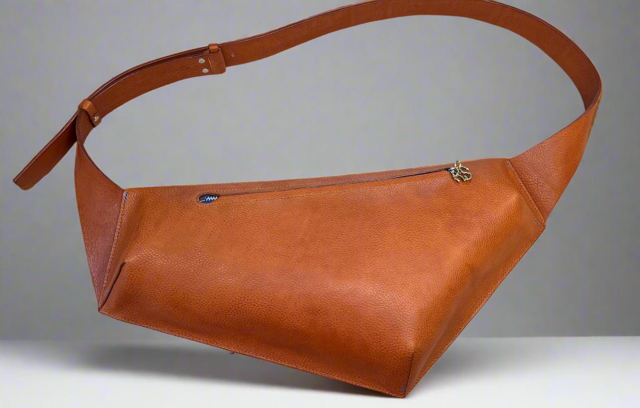 Large asymmetric cross body belt bag in tan tumbled leather with blue zip and adjustable strap