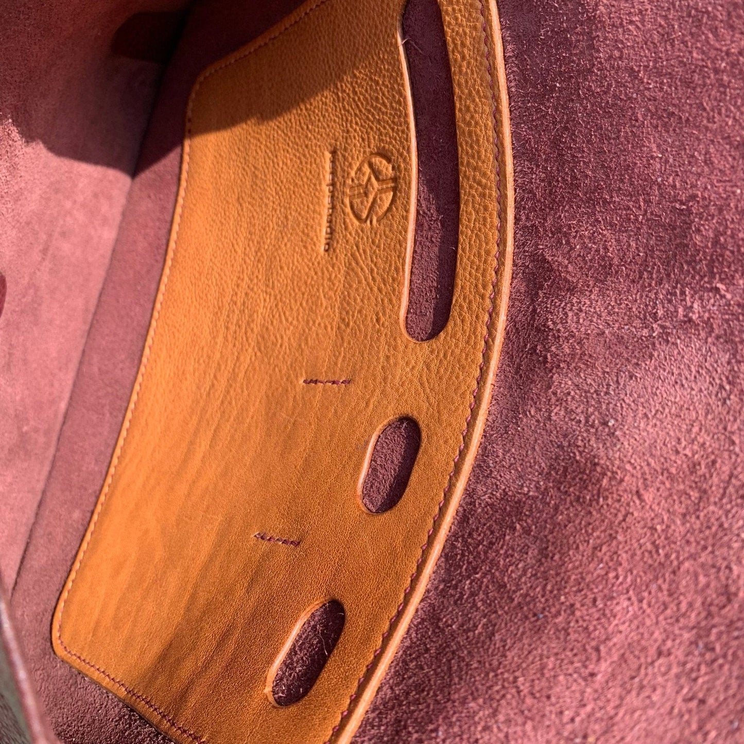 Inside detail of bag showung leather pockets for pens and phone